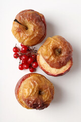 Concept of tasty food with baked apples on white background