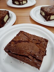Chocolate cakes serving with disposable plates.