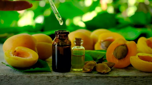 Apricot kernel essential oil in a bottle. Selective focus.