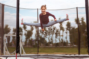 Jumping on Trampoline. Little girl jumps on trampoline.