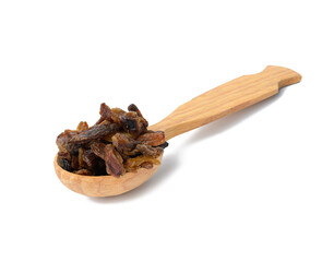 bunch of dried brown raisins in wooden spoon isolated on white background