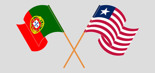 Crossed and waving flags of Portugal and Liberia