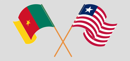 Crossed and waving flags of Cameroon and Liberia