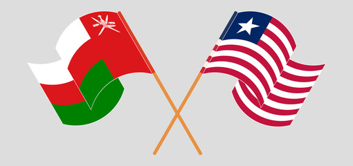 Crossed and waving flags of Oman and Liberia