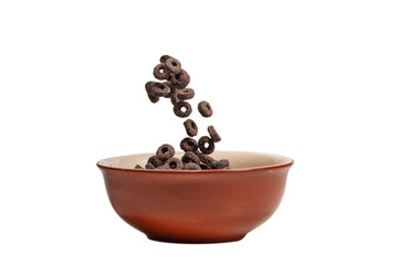 Chocolate rings cereal spill out into a bowl. Breakfast.