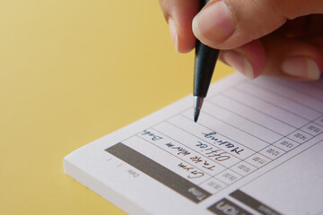 writing on a daily planner on table.