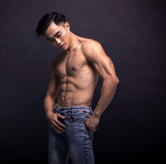 Fototapeta na wymiar Asian Strong Athletic Man Fitness Model Torso showing six pack abs