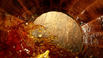 Freeze motion of splashing whisky in barrel