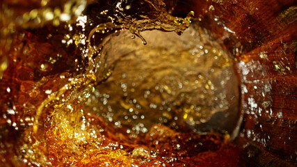 Freeze motion of splashing whisky in barrel