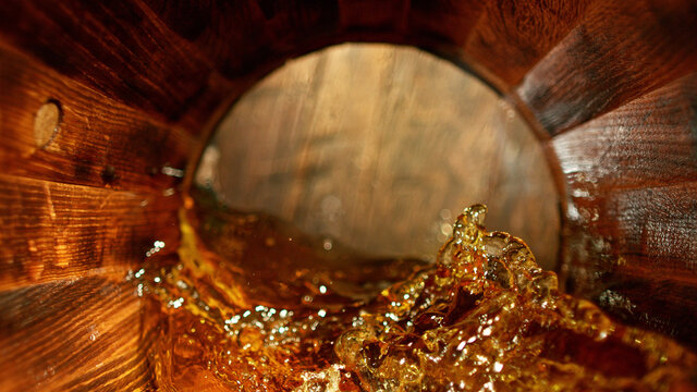 Freeze motion of splashing whisky in barrel