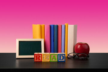 Stack of books on black wooden table