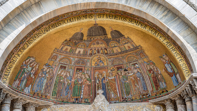 Ancient religious mosaic depicting Biblical scenes at facade of Basilica San Marco in Venice, Italy. Concept of historical and religious heritage.