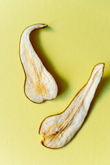 dried pears on yellow background