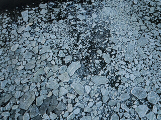 Aerial drone view on ice floes on ocean surface in Norways arctic sea