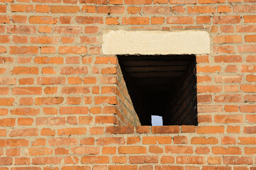 Fototapeta premium loophole in the fortress wall of the Kolomna Kremlin - red brick wall