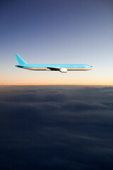 Fototapeta na wymiar Airplane traveling over the sky clouds