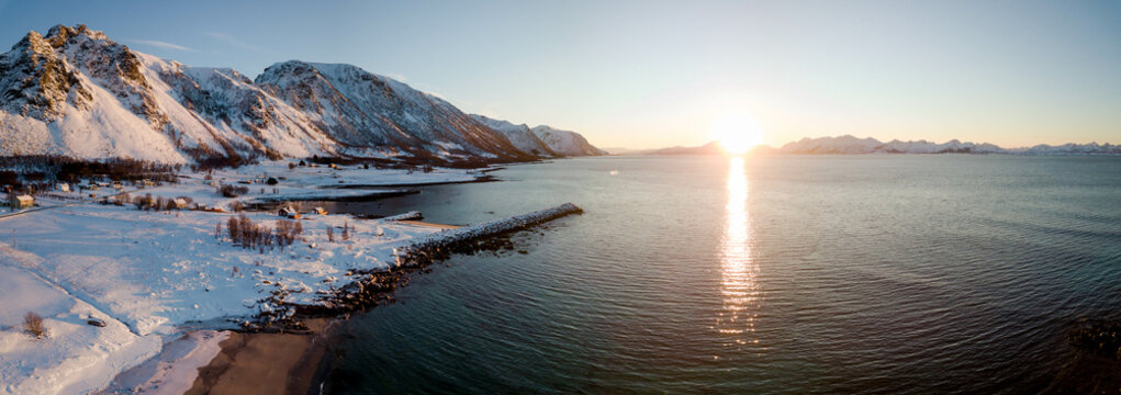 Aerial drone view of panoramic sunset of snow 
 and ice covered Norway Andøya close to Andenes