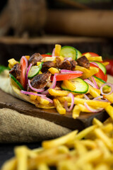 Greek gyros wrapped in pita bread on a wooden board