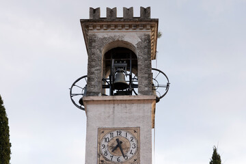 Bell tower of the church in Tremosine on Lake Garda with the church clock at half past seven o'clock