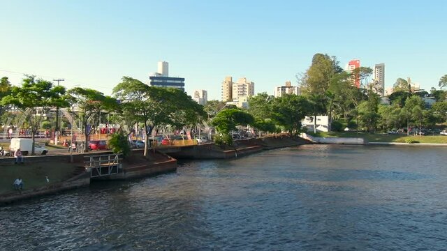 Higienopolis avenue on the banks of Igapo Lake of Londrina city at Parana state. Zoom out video.