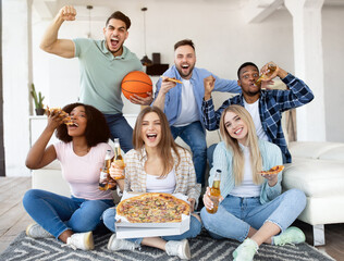 Group of diverse young friends with pizza and beer watching basketball game on TV, supporting favorite team at home