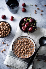 Fresh breakfast with chocolate balls with milk in a bowl