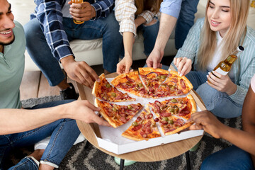 Cropped view of cheerful diverse friends enjoying party, having pizza, drinking beer at home