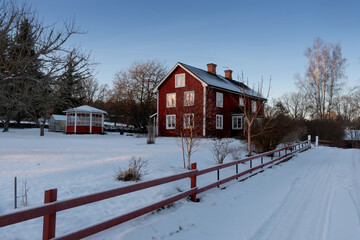 Typical farmhouse in snowy countryside in Sweden