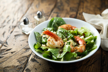 Fototapeta na wymiar Homemade Caesar salad with shrimps