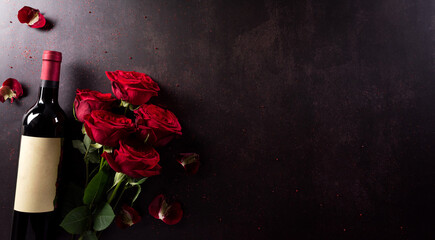 Love and Valentine's day concept made from red wine and rose on dark stone background. Top view with copy space, flat lay.