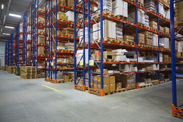 Interior of a modern warehouse storage of retail shop with pallet truck near shelves