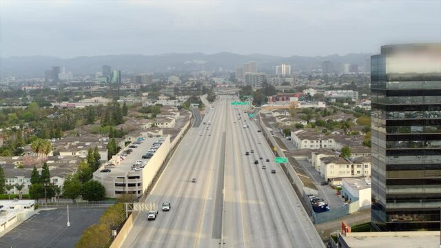 Aerial Slowly Panning Across The 405 North Highway With Light Traffic And A Hazy Horizon - Los Angeles, California