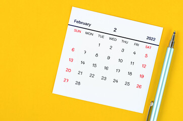 February 2022 calendar on yellow background.