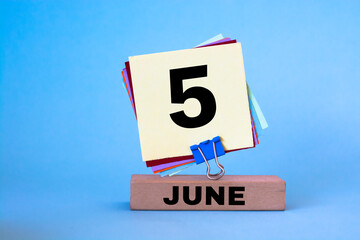 June 5th. Image of June 5 wooden color calendar on blue background. Summer day, empty space for text