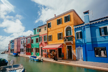 Colorful Burano island with small houses past water canals