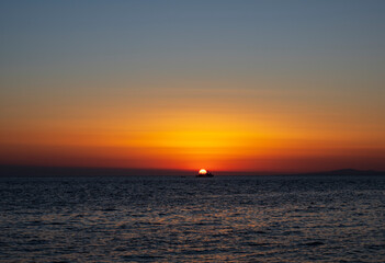 Silhouette of boat on sea beach with sunset background. Sunset moment at the sea side in Neos Marmaras, Greece.
