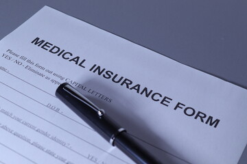 Medical Insurance Form with pen lain across the page