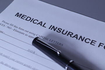 Medical Insurance Form with pen lain across the page