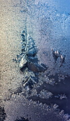 Frosty drawing on the window close-up in winter