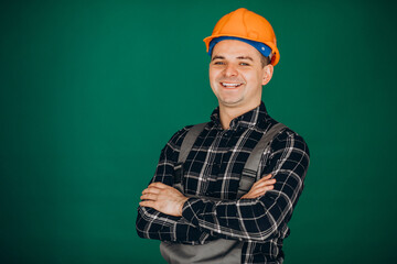Man worker in hard hat isolated on green background