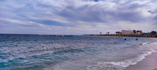 View of Abu Dabab beach and bay in Egypt. Waves in the Red Sea. Blue water and sky	