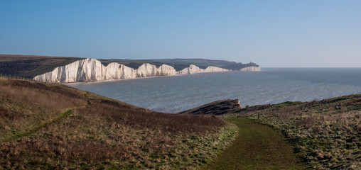 Fototapeta na wymiar View of the Seven Sisters chalk cliffs facing the English Channel at Seaford, East Sussex on the south coast of England UK. Photographed at Hope Gap.