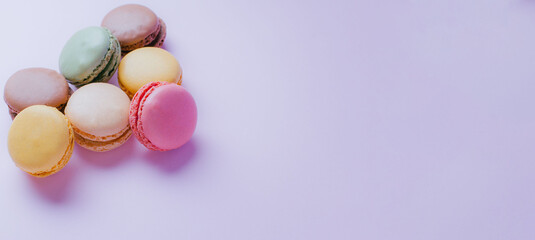 Macarons dessert on pastel tones background. Copy space.