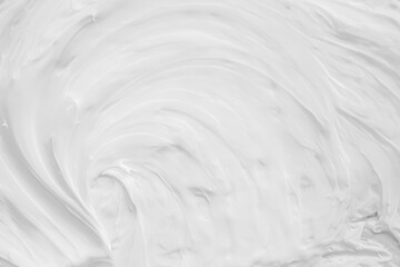 White surface of the cream lotion softens the background.