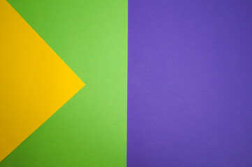 Graphic background of different geometric shapes in 3 colors: green, yellow, purple. Space copy. Trend colors.