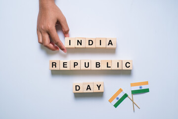 Hand of male putting wood cube block with word India Republic Day