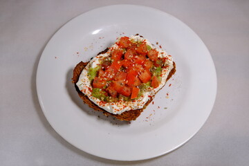 Avocado sandwiches, half of avocado, with peanuts and pumpkin seeds, tomatos on a white background
