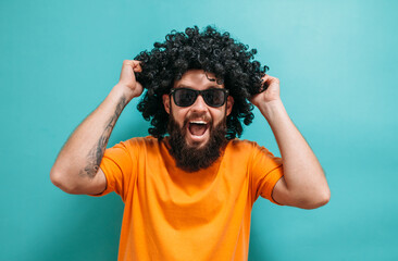 Funny bearded hipster man in wig. Smile. Crazy emotions