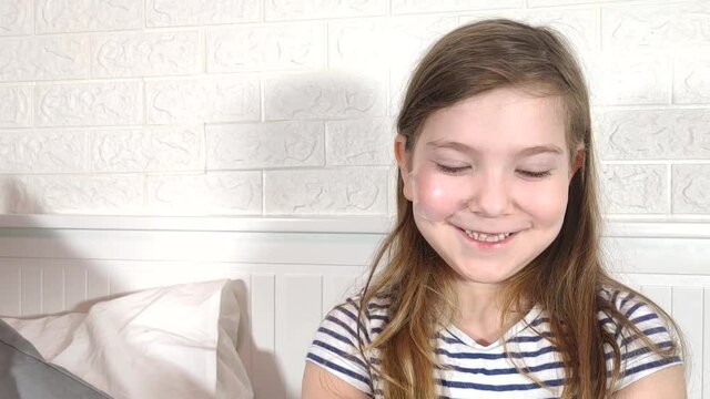 Technology and beauty vlog for kids. Cute Caucasian blogger girl doing makeup, showing cosmetics and face powder. Girl Recording Blog, Talking to Camera