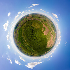 Aerial view from high altitude of little planet earth covered with white puffy cumulus clouds on sunny day © bilanol